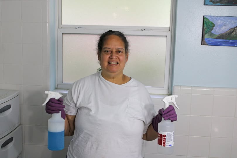 Jackie poses with her janitorial equipment